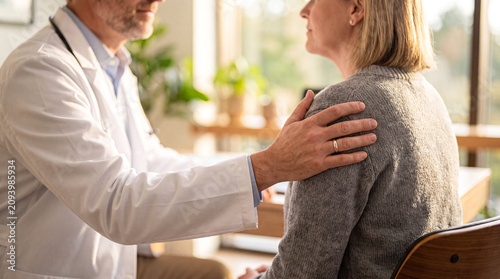 Quadro su tela Doctor Comforting a Senior Female Patient in Clinic