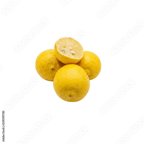 Fresh whole yellow lemons and one half cut lemon isolated on white background