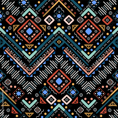 Zigzag tribal chevron seamless pattern. African, Aztec. Geometric vector oriental background. Multicolor backdrop with triangles, dots, and diamonds. Mayan Lines, stripes.