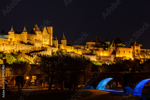 Obraz na plátně Medieval fortress on hill and bridge in Carcassonne France illuminated in night