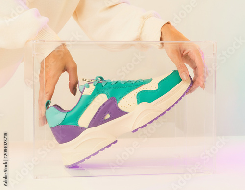Displaying Sneaker Product in Clear Box on Table with Soft Lighting and Modern Viewpoint
