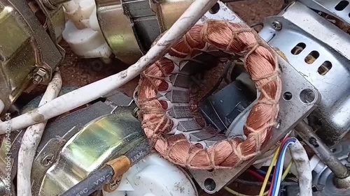 Slow Pan Right Over Pile of Discarded Fan Motor Waste. Scrap Electric Motors in E-Waste Recycling Yard. Sustainable Metal Recovery and Circular Economy Concept