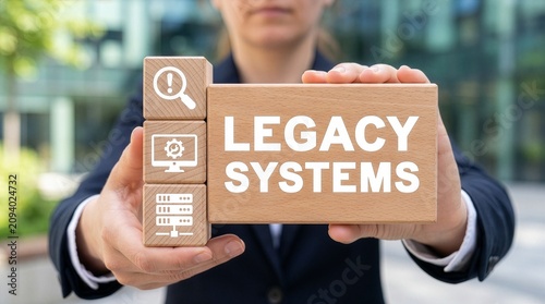 Man holding wooden blocks sees inscription LEGACY SYSTEMS. Legacy System Business Technology Interoperability Modernization concept. new concept