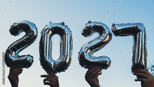 Happy new year 2027 metallic balloons on blue sky background. Greeting card silver foil balloons numbers Christmas holiday concept. Celebration party congratulation decoration