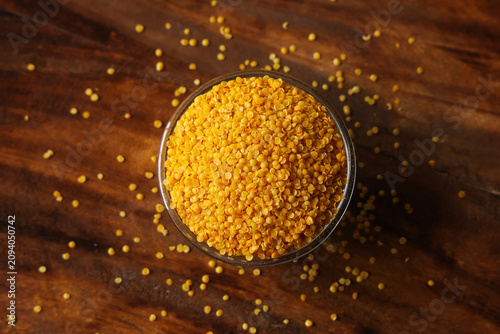 Fotografi Indian spice gentile called orange rai Dal isolated on wooden background