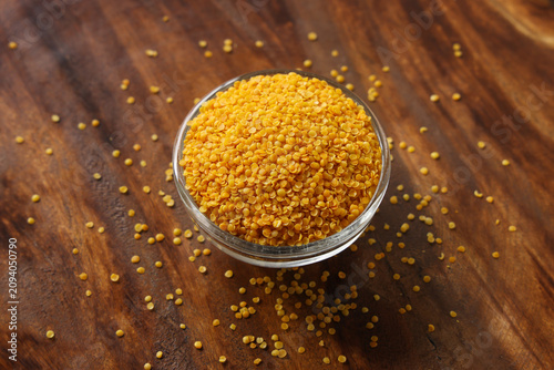 Fotografi Indian spice gentile called orange rai Dal isolated on wooden background