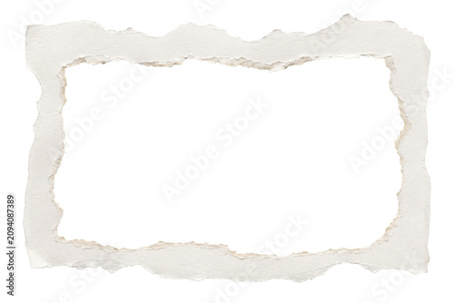 A ripped piece of paper with torn edges lies on a surface.