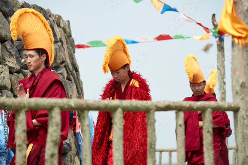 Lamas and monks chanting prayers at the Obo (cairn).