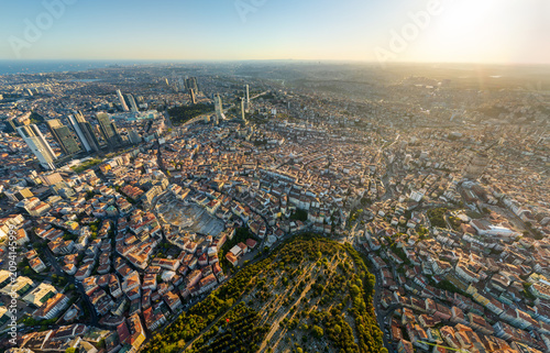 Istanbul, Turkey. Panoramic aerial drone view of European city skyline with skyscrapers, Bosphorus Strait and Zincirlikuyu Cemetery at sunset, clear sky. Aerial view