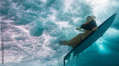Underwater Portrait of Female Surfer Holding Board Below Surface