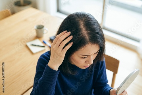 High Angle Shot of Japanese Woman Checking Hair Parting and Thinning Crown