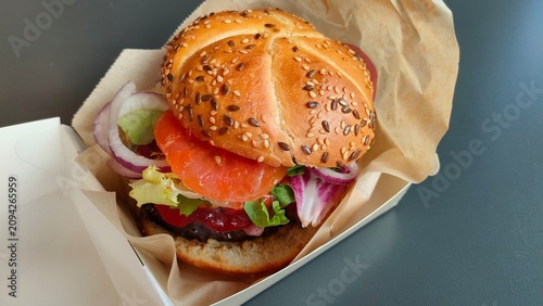 Tasty colorful hamburger in paper