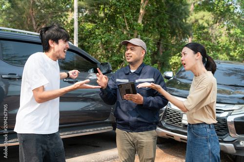 A car insurance agent mediates a heated dispute between two drivers at the scene of an accident.