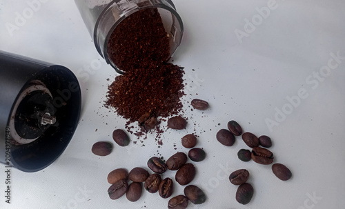 Coffee Grinder with Roasted Coffee Beans and Ground Coffee on White Background