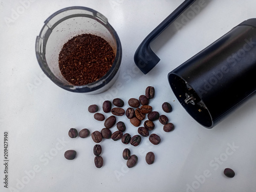 Coffee Grinder with Roasted Coffee Beans and Ground Coffee on White Background