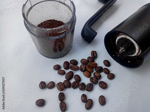 Coffee Grinder with Roasted Coffee Beans and Ground Coffee on White Background