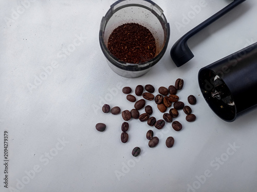 Coffee Grinder with Roasted Coffee Beans and Ground Coffee on White Background