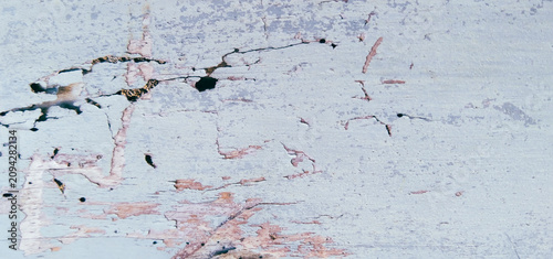 Fotografie Closeup detail of light blue paint coating an old wooden surface that is decayed