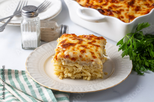 A square slice of baked macaroni with melted cheese - Turkish name; firin makarna