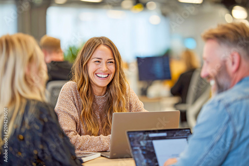 Smiling businesswoman leading meeting with colleagues in modern office