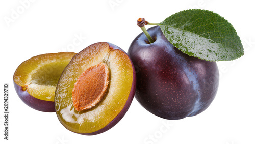 Fotografie Isolated vibrant whole and halved fresh purple plums with green leaf and exposed pit