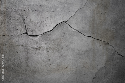 Fotografie Damaged gray cracked concrete wall background for design.