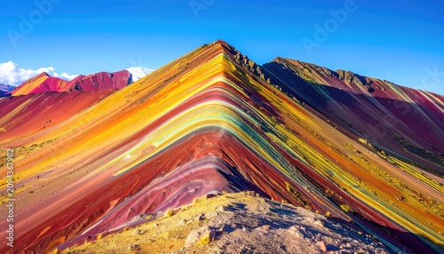 The stunningly vibrant Rainbow Mountain in Peru under a clear blue sky.