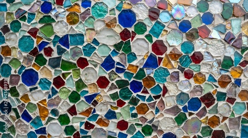 Colorful stained glass mosaic wall texture with multicolored broken glass pieces and grout