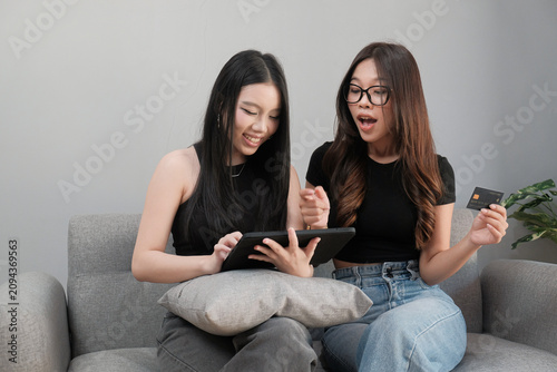 Excited Young Asian Women Shopping Online with Digital Tablet and Credit Card