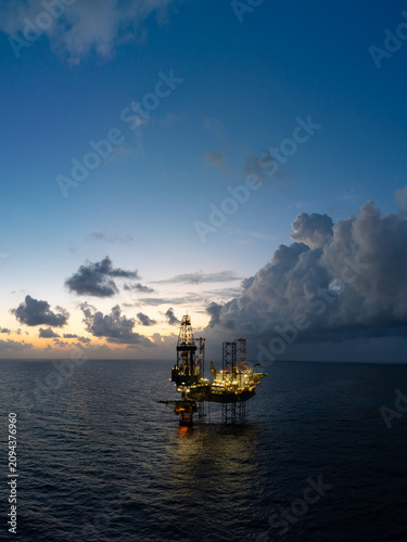 Aerial panoramic view of offshore jack up rig and offshore platform for oil and gas exploration and production.
