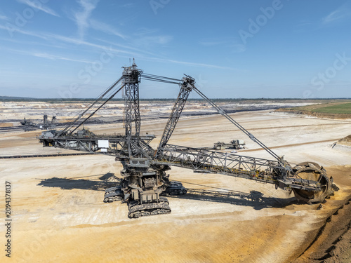 Lignite mining near Aachen, Germany, with terraced earthworks and industrial machinery extracting fuel for coal-fired power stations.
