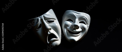Two white theatre masks, one sad and one happy, are juxtaposed against a dark background