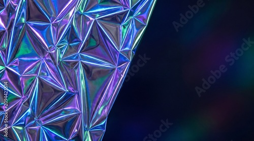 Holographic foil texture with a shimmering geometric pattern creating a luxury background design featuring modern 3D glassmorphism elements and iridescent metallic reflections