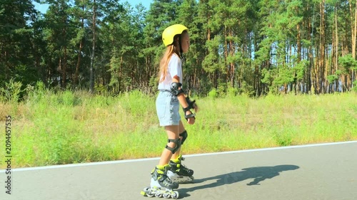 Girl is roller skating by forest, enjoying an active hobby in the open air.