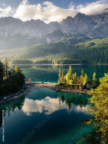 Fotografía Scenic summer landscape of a calm turquoise alpine lake reflecting white clouds