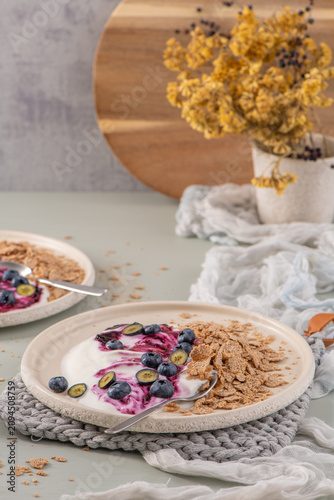 Healthy breakfast plates with yogurt berry compote and cereal