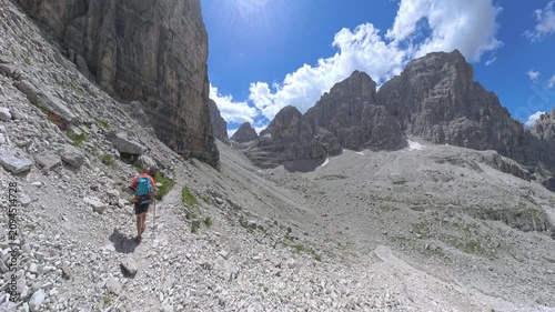 Mountain hiker approaching the Via Ferrata Bocchette Centrali near Bocca di Brenta, Dolomites, Italy