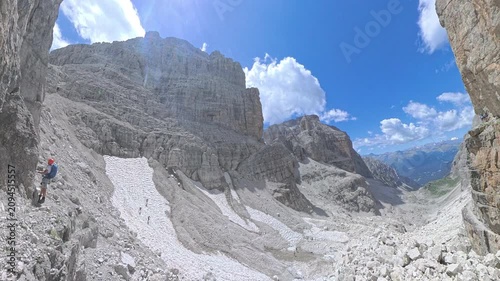 Group of climbers entering the Via Ferrata Bocchette Centrali above Brenta Valley, Italian Dolomites