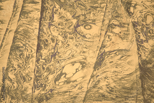 Vintage Ebru Abstract Brown and Gold Marble Texture Pattern with Swirls and Waves in a Natural Design, Evoking a Sense of Motion and Depth
