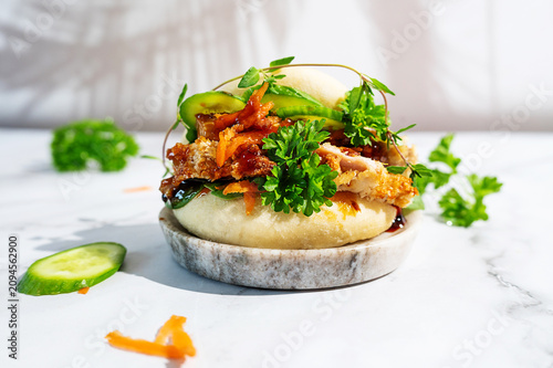 Trendy teriyaki chicken bao sliders on a stylish platter.