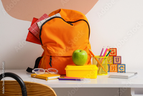 Orange backpack with school...
