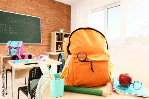 Orange backpack with school...