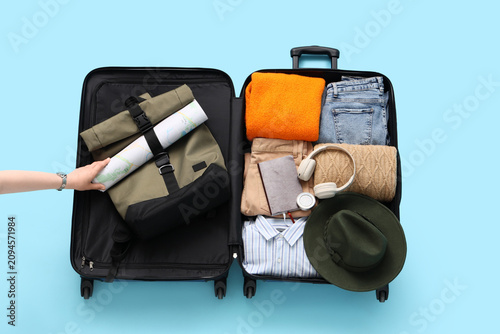 Open suitcase packed with t...