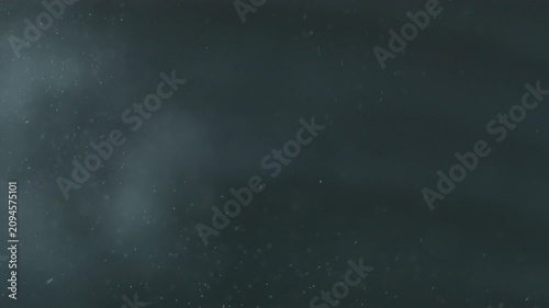 Real dust particles floating over dark background.