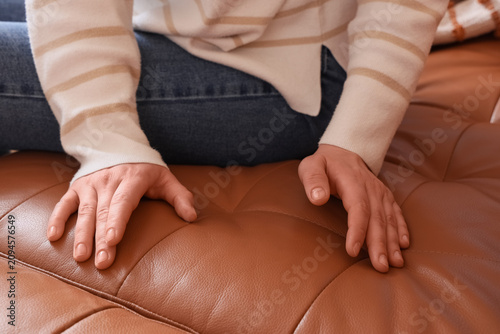 Womans hands resting on a b...