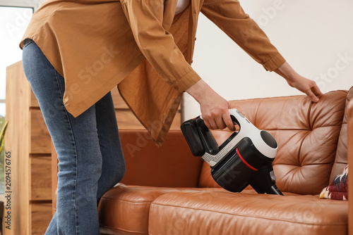 Woman cleaning a brown leat...