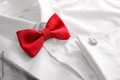 Canvas Print Red bow tie and silver cufflink on a crisp white dress shirt, formal attire for