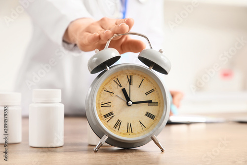 Female doctor turning off a...