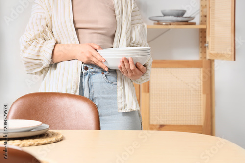Young woman with stack of c...