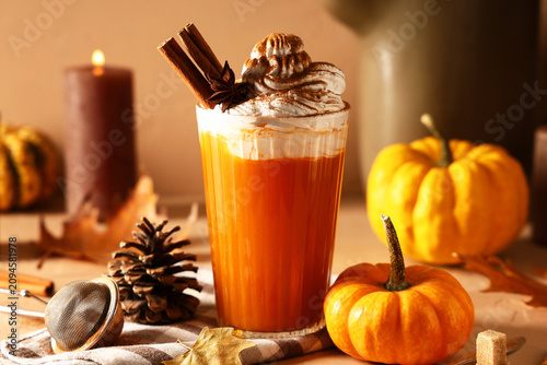Glass of orange pumpkin lat...